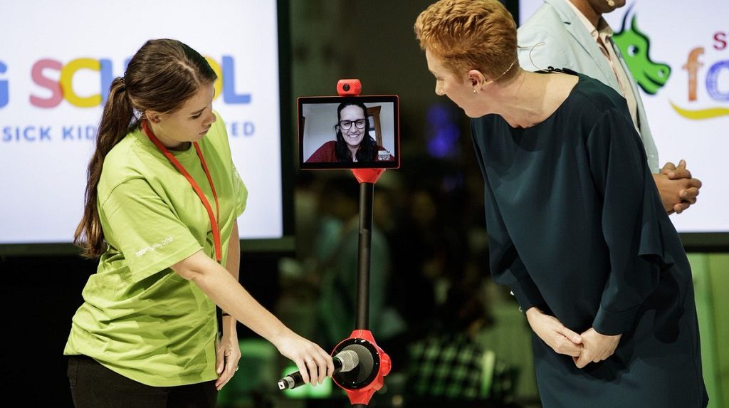 Meghan Gilmour, founder of MissingSchool demonstrating the robots.