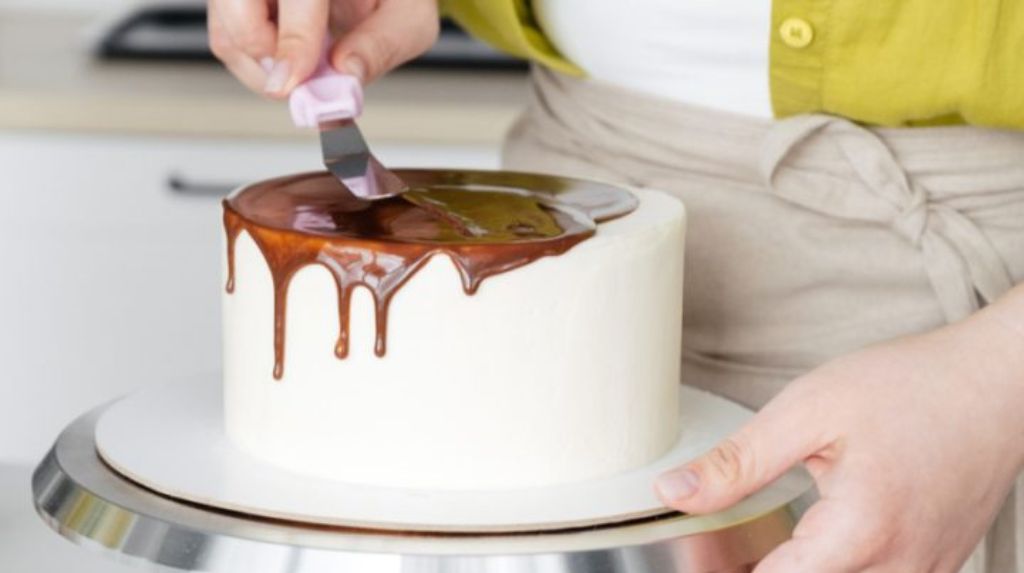 Stock image, woman icing cake